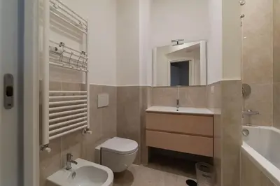 a bathroom with a sink and a toilet and a tub at GuestHost - Charming Apartment Metro Cipro in Rome