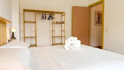a bedroom with a bed with two rolled towels at Stylish Apt Balcony, AC,Aqueduct View in Rome