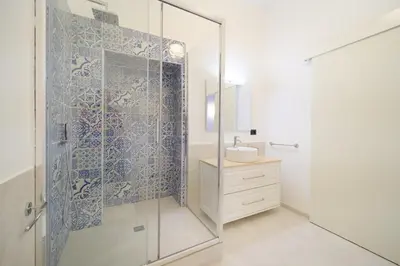 a bathroom with a glass shower and a sink at Dadada by BuddyRent in Rome