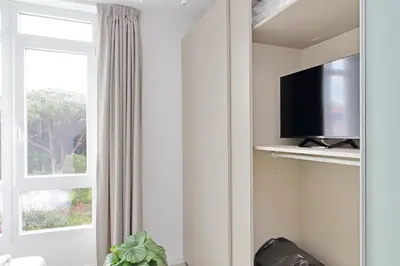 a living room with a tv and a window at Luminoso appartamento di fronte Metro Piramide in Rome