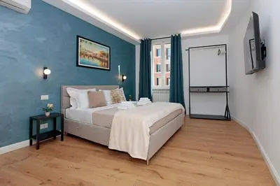 a bedroom with a bed and a flat screen tv at Malva Suite in Rome