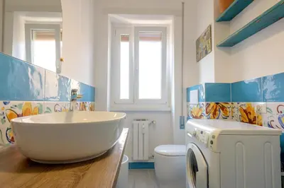 a bathroom with a tub and a washing machine at Vacanze Romane in Rome