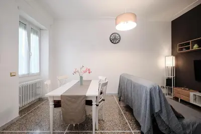 a white dining room with a table and a bed at Residenza Lucis - Camillo Hospital - Monteverde by Hôtea in Rome