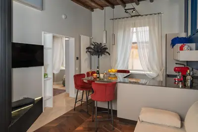 a kitchen with a bar and red chairs in a room at Dreamers in Belsiana Spagna int 8 in Rome