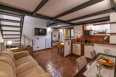 a kitchen and living room with a couch and a table at Domus Campo de Fiori in Rome