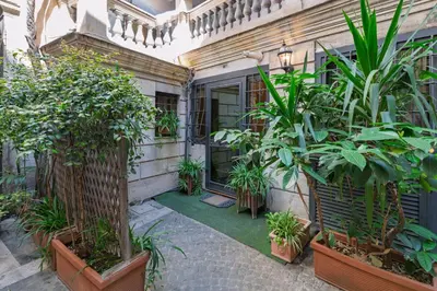 a courtyard of a house with plants in pots at Domus Campo de Fiori in Rome