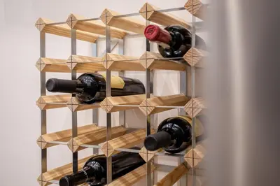 a wine rack with bottles of wine in it at MyRentalInn Scarlatti Rhome Parioli in Rome
