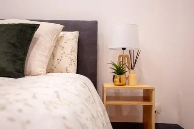 a bedroom with a bed and a table with a lamp at MyRentalInn Scarlatti Rhome Parioli in Rome