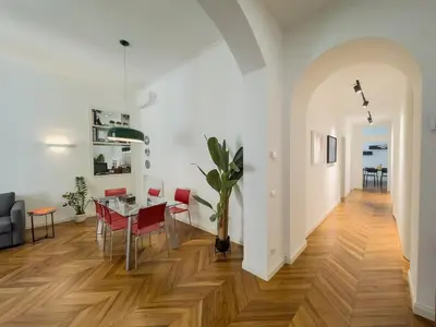a dining room and living room with a table and chairs at Casa Alessandria in Rome