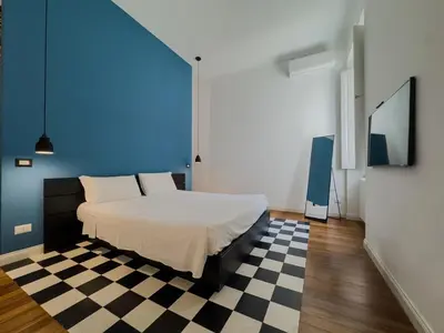 a bedroom with a bed and a checkered floor at Casa Alessandria in Rome