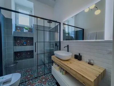 a bathroom with a sink and a glass shower at Casa Alessandria in Rome