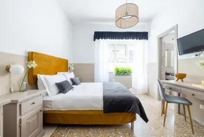 a bedroom with a bed and a desk with a computer at Next Stop Vatican Guest House in Rome