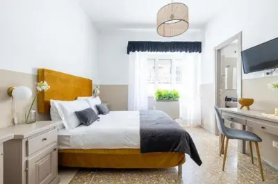 a bedroom with a bed and a desk with a computer at Next Stop Vatican Guest House in Rome