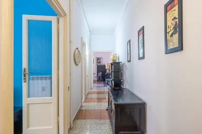 a hallway with a room with a door and a table at Flaminio Tiepolo bright and central in Rome in Rome