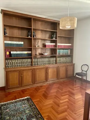 a room with a large wooden book shelf at Testaccio 100 in Rome