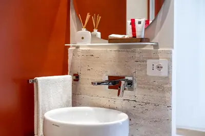 a bathroom with a sink and a mirror at Petra Apartments San Giovanni in Rome