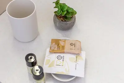 a table with a cup and a box and a plant at iFlat New Refined Apartment Near the Vatican in Rome