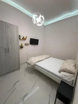 a bedroom with a bed and a tv on the wall at BANGA HOUSe in Rome