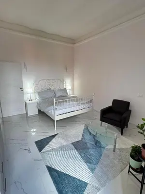 a living room with a bed and a chair at BANGA HOUSe in Rome