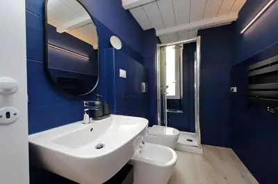 a blue bathroom with a sink and a toilet at Elegance in Parioli Rome La casa di Pigi in Rome