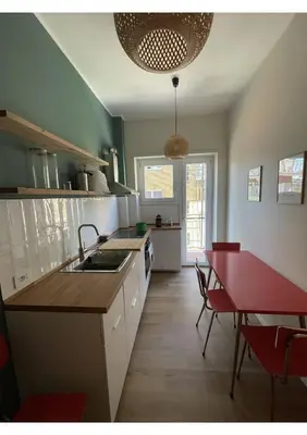 a kitchen with a sink and a table with chairs at Bonci Rooms - Appartamento in zona Policlinico Gemelli, Università Cattolica, Vaticano, Stadio Olimpico in Rome