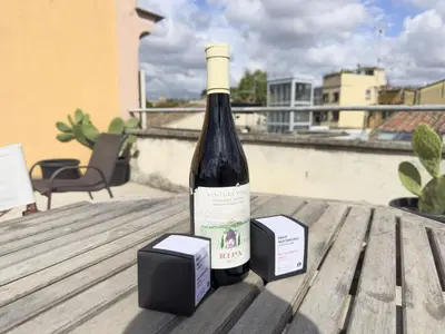 a bottle of wine sitting on a wooden table at Trastevere Romantic Nest in Rome