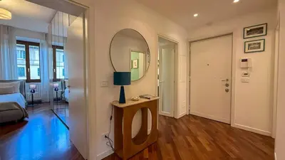 a living room with a bed and a mirror at Elegant Roman Escape Walk to the Colosseum in Rome