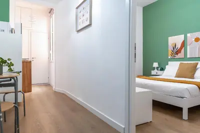 a bedroom with a bed and a table and a chair at City Comfort - 20 minutes walk to the Colosseum in Rome