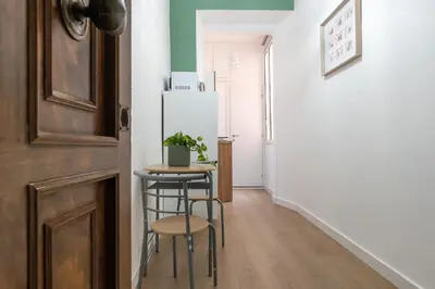 a small kitchen with a table and stools in a room at City Comfort - 20 minutes walk to the Colosseum in Rome