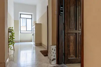 a hallway with a wooden door and a room at City Comfort - 20 minutes walk to the Colosseum in Rome