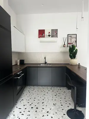 a kitchen with a sink and a counter top at Casa Conce two metro stops from the colosseum in Rome