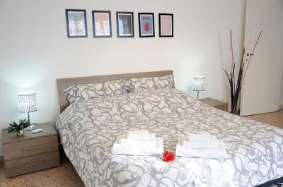 a bedroom with a bed with two towels on it at Casa Vacanze Kokoroma Cipro al Vaticano in Rome