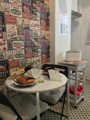 a table in a room with a wall of soda signs at Casa Vacanze Kokoroma Cipro al Vaticano in Rome