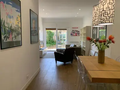 a living room with a vase of flowers on a table at Casa Fabio - Cornelia Metro A in Rome
