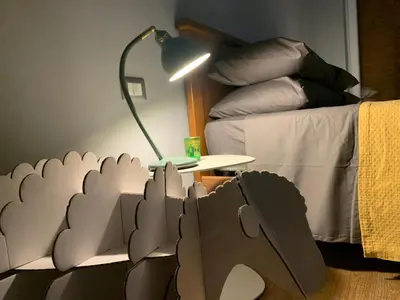 a room with a bed and a table with a lamp at Casa Fabio - Cornelia Metro A in Rome