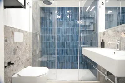a bathroom with a toilet and a sink and a shower at 1886 Colosseo Suite in Rome