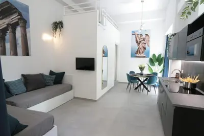 a living room with a couch and a table at 1886 Colosseo Suite in Rome