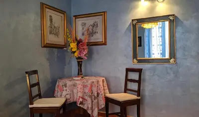a table with two chairs and a vase with flowers on it at B&B Prati in Rome