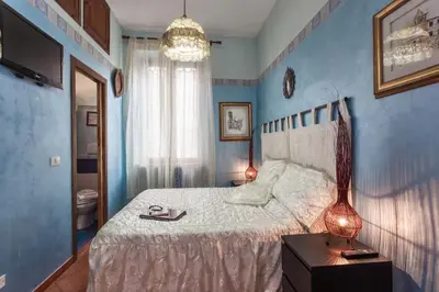 a bedroom with a large bed with blue walls at B&B Prati in Rome