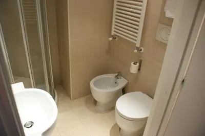 a small bathroom with a toilet and a sink at Hotel Aniene in Rome