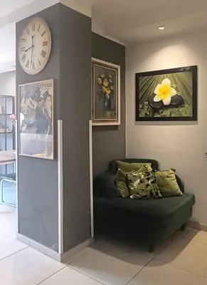 a room with a couch and a clock on the wall at Hotel Aniene in Rome