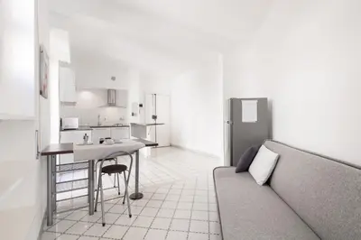 a living room with a couch and a kitchen at Margaret Guest House in Rome