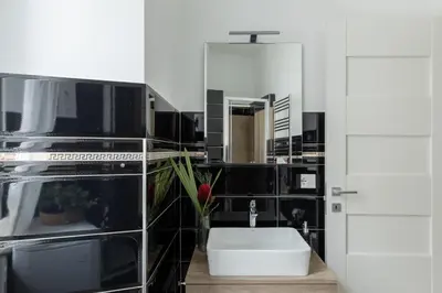 a bathroom with a white sink and a mirror at iFlat Vatican Modern & Comfortable Peaceful Gem in Rome