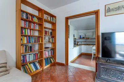 a living room with book shelves filled with books at iFlat Pantheon & La Dolce Vita Skyline Penthouse in Rome