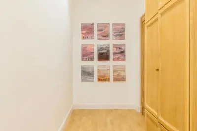 a room with white walls and paintings on a wall at Suite23 , Roma in Rome