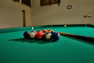 a group of billiard balls on a pool table at TreasureRome Trevi Private Palazzo in Rome
