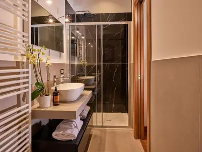 a bathroom with a sink and a shower at TreasureRome Trevi Private Palazzo in Rome