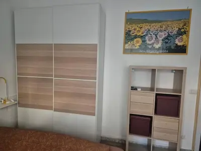 a bedroom with a bed and a dresser and a painting at La casetta di Laura al Gemelli-Vaticano in Rome