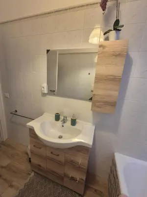 a bathroom with a sink and a mirror and a tub at La casetta di Laura al Gemelli-Vaticano in Rome