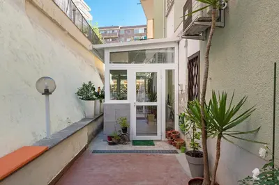 an entrance to a building with a door and plants at Art & Garden Gemelli - Metro A - Vaticano in Rome